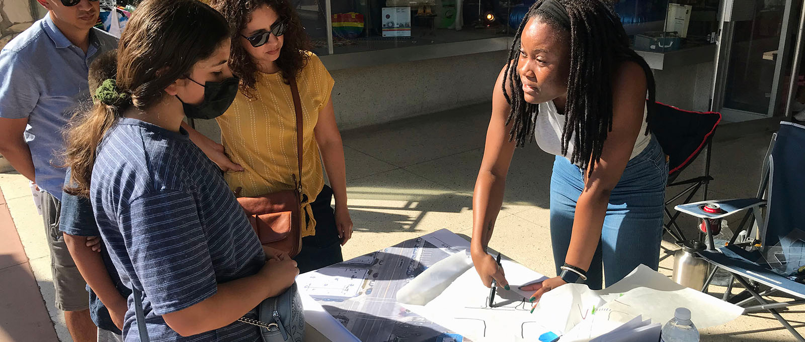 People discussing papers on a table